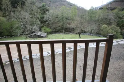 a view of a river from a wooden railing at Casa Grande da Ferreria de Rugando in Rugando