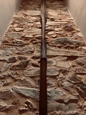 a sword hanging on a stone wall at The Pilgrim Stone - Vegan B&B in Rabanal del Camino
