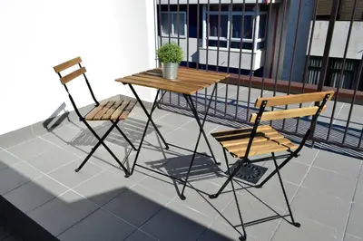 two chairs and a table on a balcony at Hotel Alda Estación Ourense in Ourense