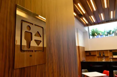 a restroom sign on the wall of a restaurant at Hotel Alda Estación Ourense in Ourense