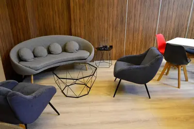a living room with two chairs and a couch at Hotel Alda Estación Ourense in Ourense