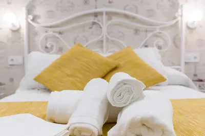 a pile of towels sitting on top of a bed at La Pause in Arzúa