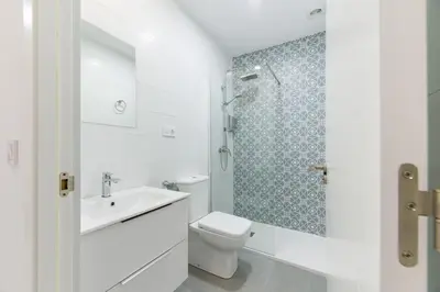 a bathroom with a toilet and a sink and a shower at La Pause in Arzúa