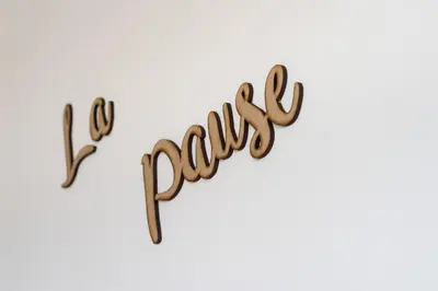 a sign that says go crazy written in wooden letters at La Pause in Arzúa