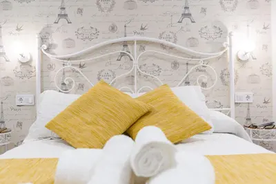 a bedroom with a white bed with two pillows at La Pause in Arzúa