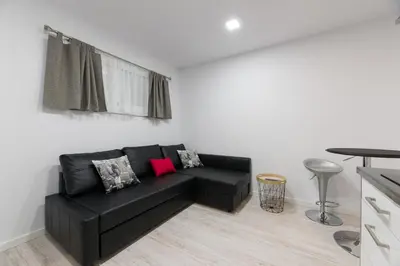 a living room with a black couch and a table at La Pause in Arzúa