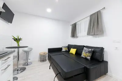 a living room with a black couch and a table at La Pause in Arzúa