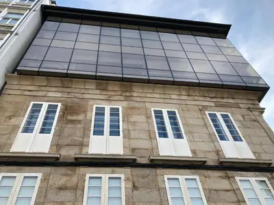 a building with windows on the side of it at Lugo 360 in Lugo