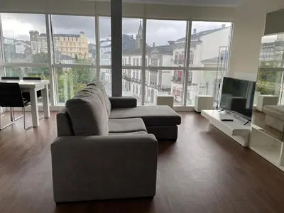 a living room with a couch and a tv at Lugo 360 in Lugo