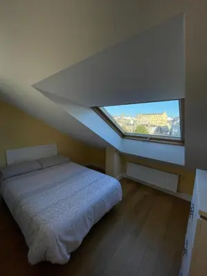 a bedroom with a bed and a large window at Lugo 360 in Lugo