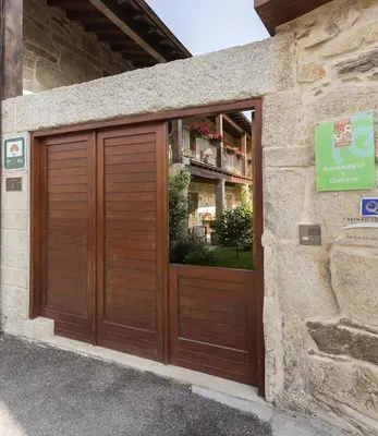 a wooden garage door on the side of a building at Casa Ramiras in O Viso