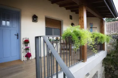 a porch of a house with a fence and plants at Casa Ramiras in O Viso