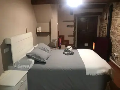 a bedroom with a bed with a stuffed animal on it at Casa Rural del Acebo in Espinoso de Compludo