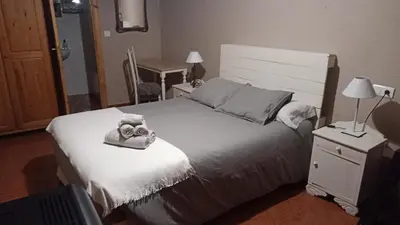 a bedroom with a bed with two towels on it at Casa Rural del Acebo in Espinoso de Compludo