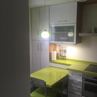 a kitchen with a green counter and a light at Bierzo centro in Ponferrada