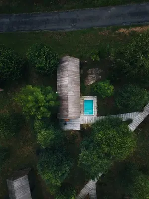 an overhead view of a wooden house with a blue door at MU_MORADAS NO ULLA in Teo