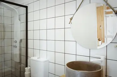 a bathroom with a tub next to a toilet and a mirror at MU_MORADAS NO ULLA in Teo