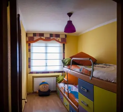 a childs bedroom with two bunk beds and a window at SAN CIPRIAN 