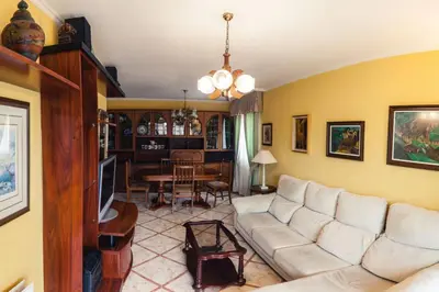 a living room with a white couch and a tv at SAN CIPRIAN 
