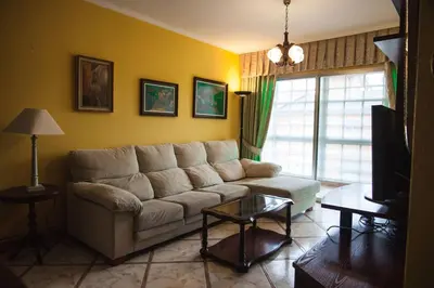 a living room with a couch and a tv at SAN CIPRIAN 