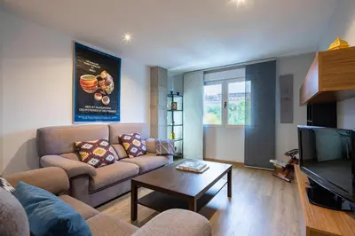 a living room with a couch and a tv at Ponferrada Castillo in Ponferrada