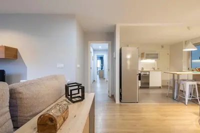 a living room with a couch and a kitchen at Ponferrada Castillo in Ponferrada