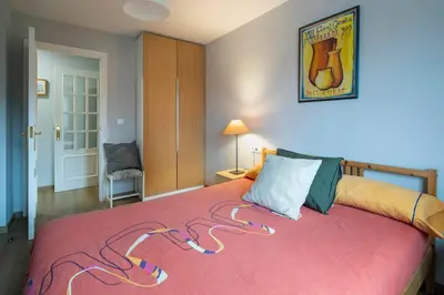 a bedroom with a large bed with a red blanket at Ponferrada Castillo in Ponferrada