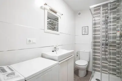 a white bathroom with a sink and a toilet at Ponferrada Castillo in Ponferrada