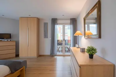 a bedroom with a bed and a desk with a mirror at Ponferrada Castillo in Ponferrada