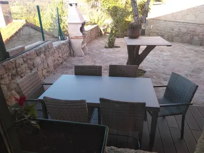 a white table and chairs on a patio at Casa Spa en montaña in Pontevedra