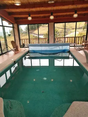 a swimming pool with avertisementatronatronstrationstrationstrationstrationstrationstration at Casa Spa en montaña in Pontevedra