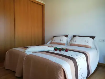 a bedroom with a large bed with flowers on it at Pedrouzo Suites in O Pedrouzo