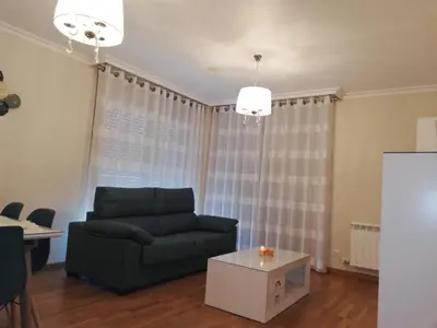 a living room with a couch and a table at Pedrouzo Suites in O Pedrouzo