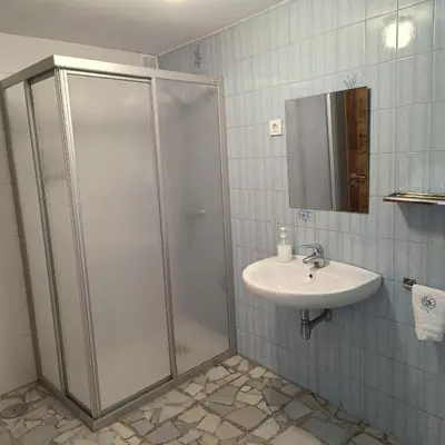 a bathroom with a shower and a sink at Pensión Rural para Peregrinos 