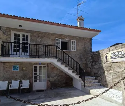 a building with a staircase in front of it at Pensión Rural para Peregrinos 