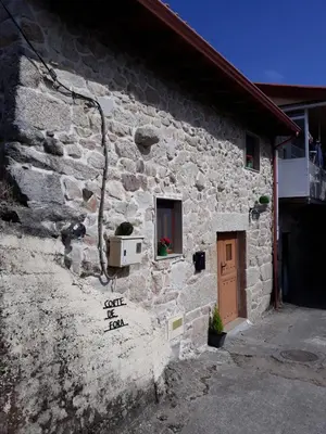 a stone building with a door and a window at Loft Corte de Fora in Ourense