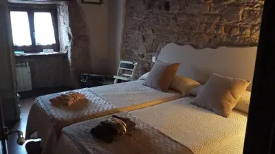 two beds in a bedroom with towels on them at A Brava in Sas de Penelas
