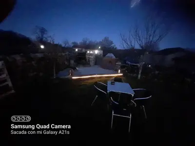 a picnic table in a yard at night at A Brava in Sas de Penelas