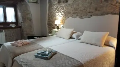 a bedroom with two beds with a tray on top at A Brava in Sas de Penelas