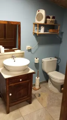 a bathroom with a sink and a toilet and a mirror at A Brava in Sas de Penelas