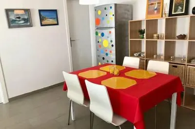 a dining room with a red table and white chairs at La Casa de Antón in Tineo