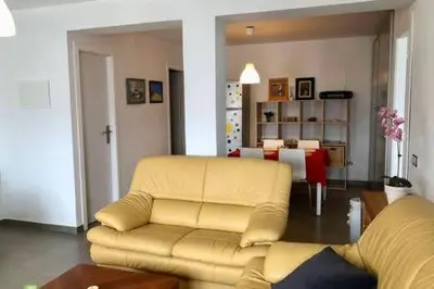 a living room with a yellow couch and a table at La Casa de Antón in Tineo