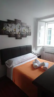 a bedroom with a bed with two towels on it at Apartamento Algalia Catedral in Santiago de Compostela