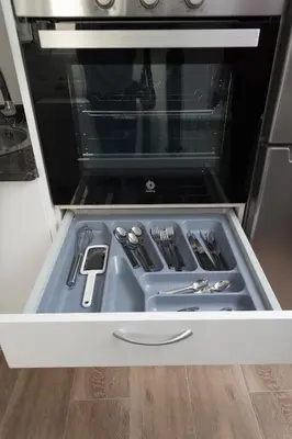 a drawer in an oven with utensils in it at Apartamento Algalia Catedral in Santiago de Compostela