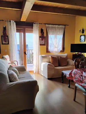 a living room with two couches and a window at El Mirador del Bierzo in Tedejo