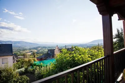 a balcony of a house with a view of a city at El Mirador del Bierzo in Tedejo