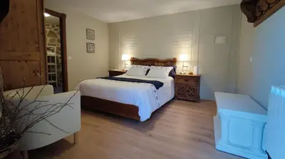 a bedroom with a large bed with white sheets and pillows at Casa de Turismo Rural Sabariz in Sabariz