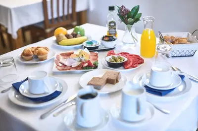 a white table with plates of food on it at Casa de Turismo Rural Sabariz in Sabariz