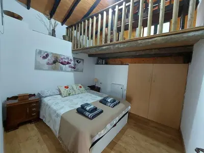 a bedroom with a bed with two towels on it at La Casa de las Rocas - En la Ribeira Sacra in Nogueira de Ramuin