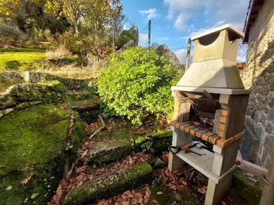 an outdoor oven sitting on the side of a building at La Casa de las Rocas - En la Ribeira Sacra in Nogueira de Ramuin